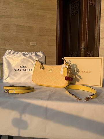 COACH LIGHT PASTEL YELLOW BAG WITH CHERRY CHARM AND 2 STRIPS