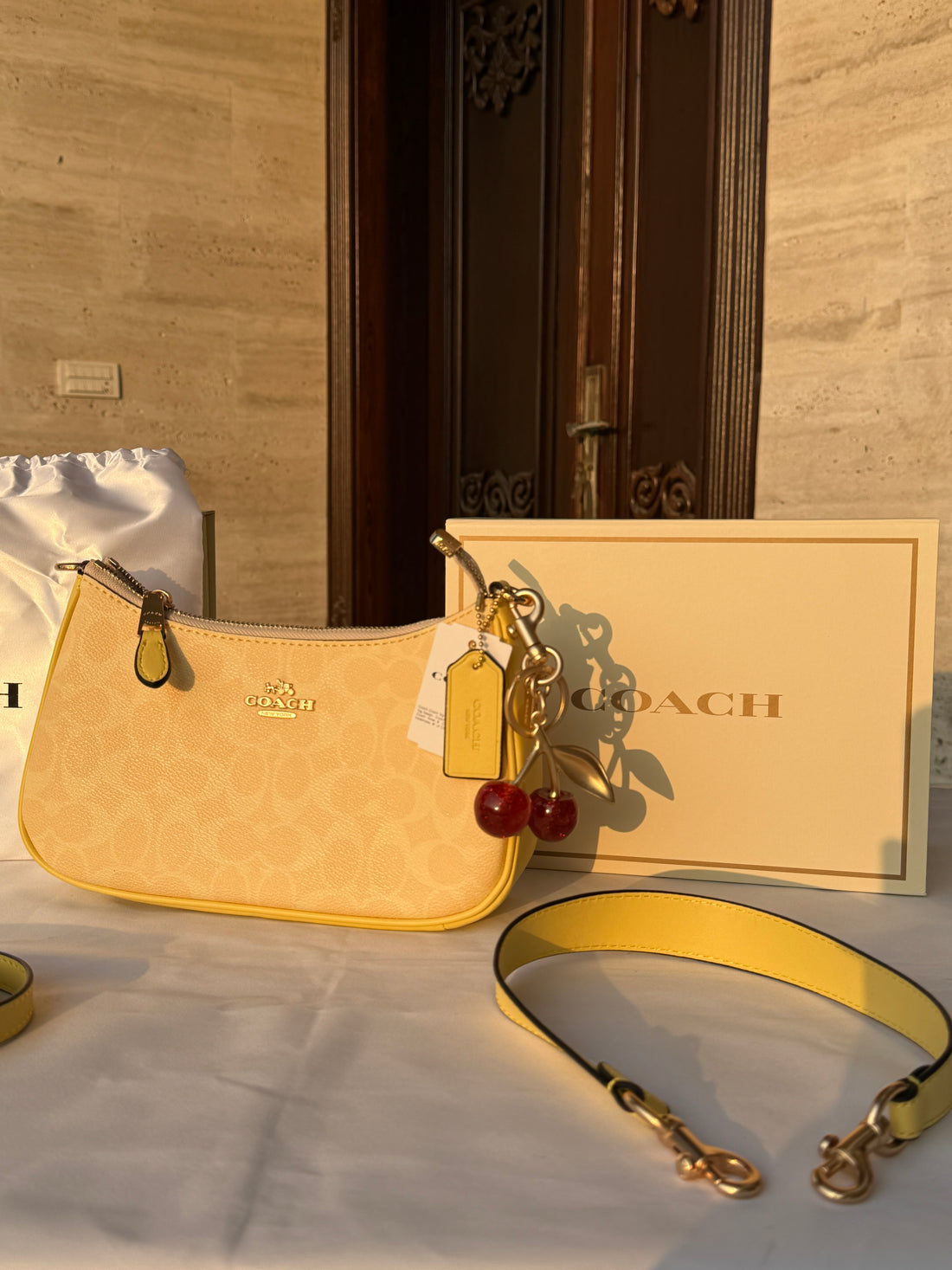 COACH LIGHT PASTEL YELLOW BAG WITH CHERRY CHARM AND 2 STRIPS