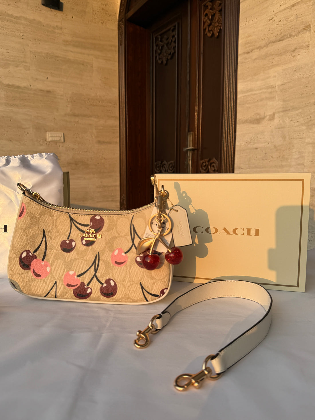 COACH BEIGE CHERRY PATTERN BAG WITH CHERRY CHARM AND 2 STRIPS