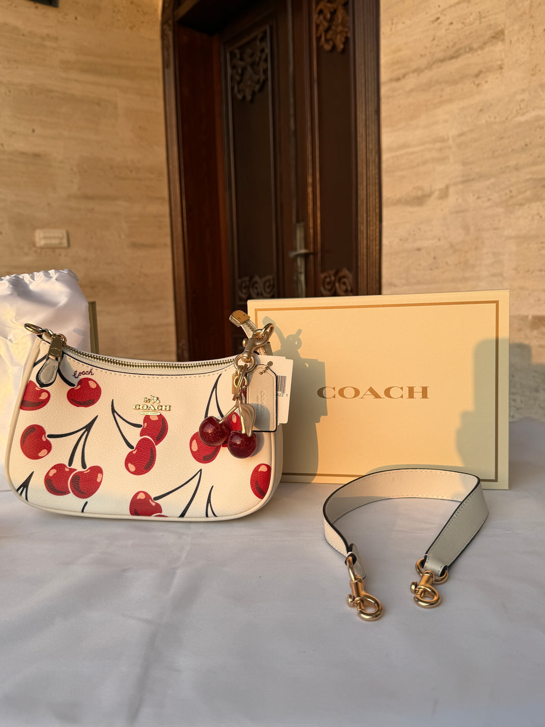 COACH WHITE CHERRY PATTERN BAG WITH CHERRY CHARM AND 2 STRIPS