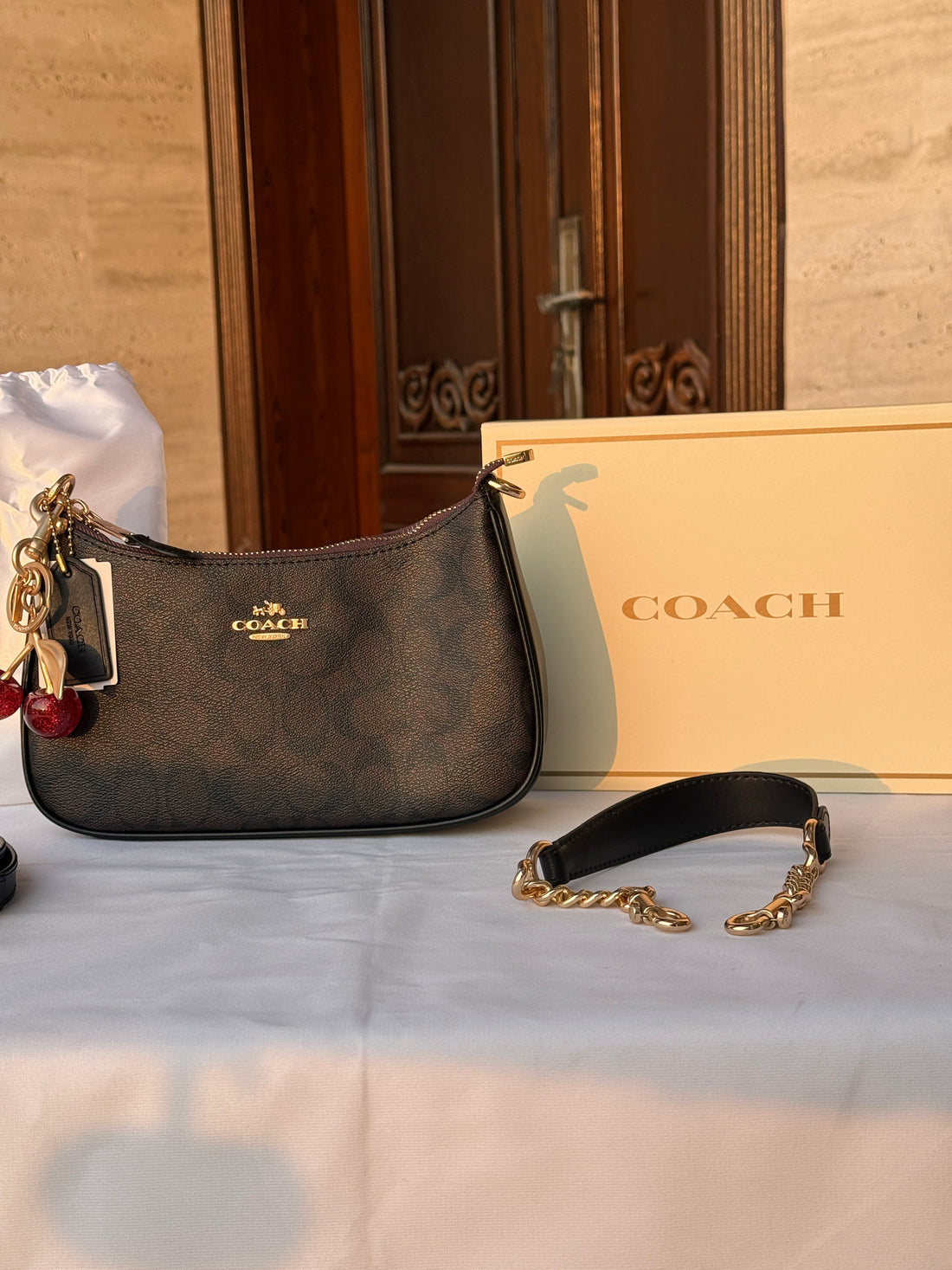 COACH BLACK PATTERN BAG WITH CHERRY CHARM AND 2 STRIPS