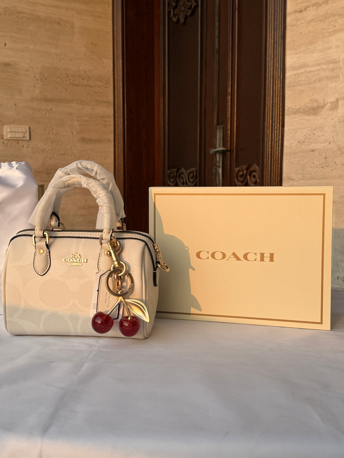 COACH WHITE PATTERN BAG WITH CHERRY CHARM