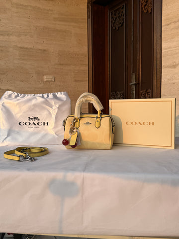 COACH LIGHT PASTEL YELLOW BAG WITH CHERRY CHARM