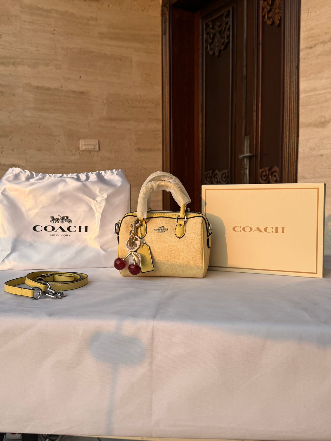 COACH LIGHT PASTEL YELLOW BAG WITH CHERRY CHARM
