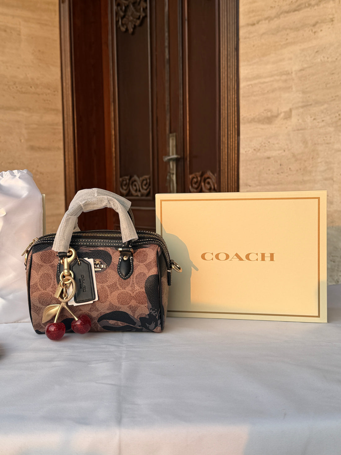 COACH BROWN WITH BLACK PATTERN BAG AND CUTE CHERRY CHARM