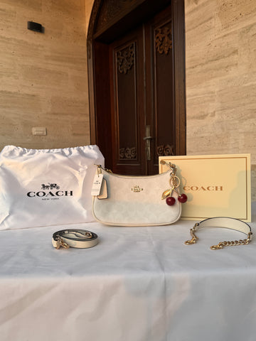 COACH WHITE PATTERN BAG WITH CHERRY CHARM AND 2 STRIPS