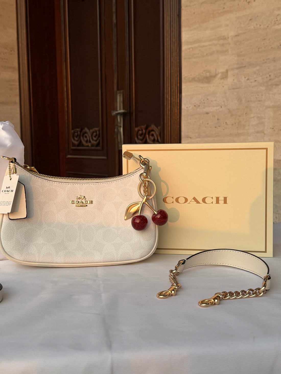 COACH WHITE PATTERN BAG WITH CHERRY CHARM AND 2 STRIPS